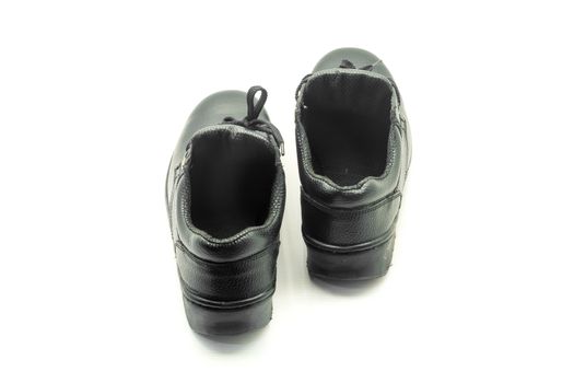 Protective workwear black safety shoes on white background.