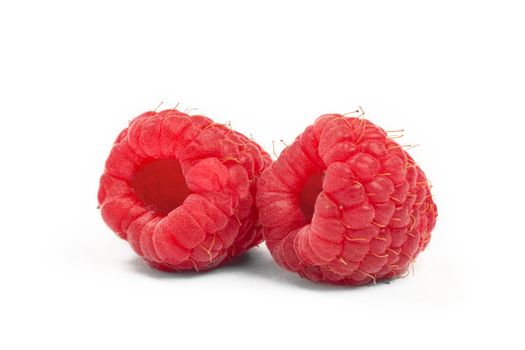 ripe raspberries isolated on white background close up.
