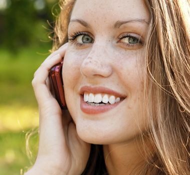 Closeup portrait of young woman talk on mobile telephone