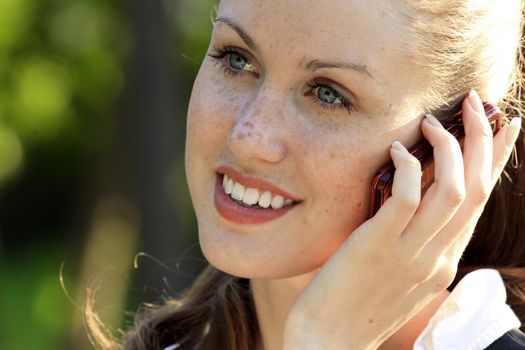 Closeup portrait of young woman talk on mobile telephone