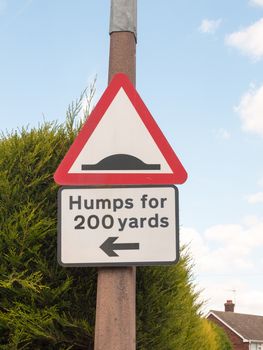 a traffic sign on a post outside humps for 200 yards direction pointer; England; UK