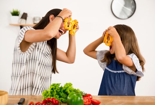 Shot of a mother and daughter having fun in the kitchen