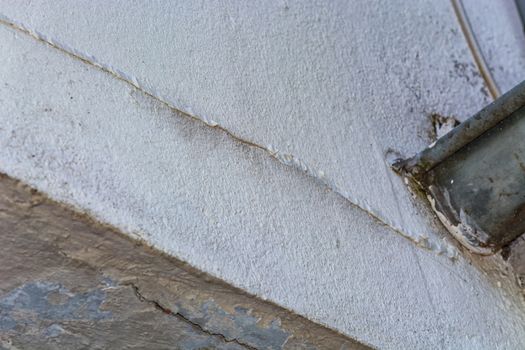 Small cracks in the plaster on the outer wall of the caused by a structural damage.
