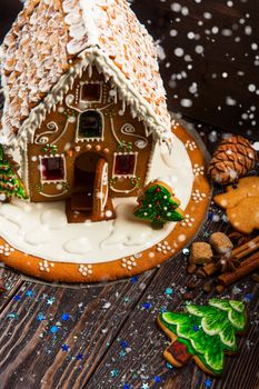 Gingerbread house with lights on dark background, xmas theme