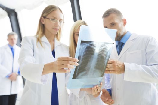 Clinic, people, healthcare and medicine concept - group of medics with chest x-ray scan at hospital