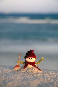 Toy of the snowman on beach background