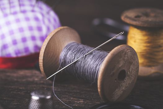 Sewing instruments, threads, needles, bobbins and materials. Studio photo