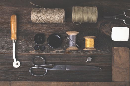 Sewing instruments, threads, needles, bobbins and materials. Studio photo