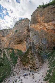 Rinka waterfall in beautiful Alpine valley, Logarska dolina - Logar valley in Slovenia. It's a popular tourist hiking destination in pristine nature surrounded by mountains