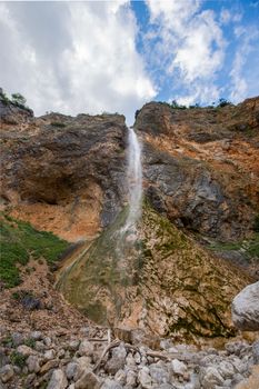 Rinka waterfall in beautiful Alpine valley, Logarska dolina - Logar valley in Slovenia. It's a popular tourist hiking destination in pristine nature surrounded by mountains