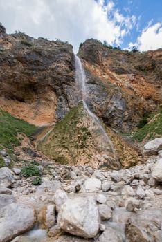 Rinka waterfall in beautiful Alpine valley, Logarska dolina - Logar valley in Slovenia. It's a popular tourist hiking destination in pristine nature surrounded by mountains
