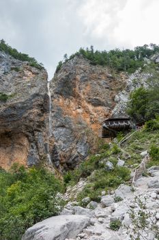 Rinka waterfall with eagles nest lookout in Logar - Logarska valley, Slovenia is a popular hiking destination in the Alps