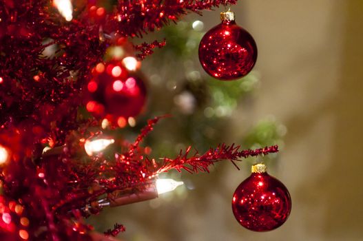 two red christmas balls in christmas tree