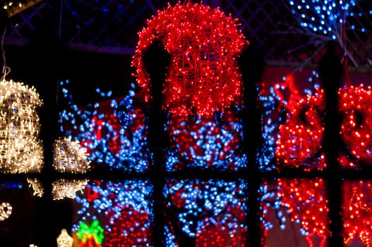 red light ball behind iron railings, many lights