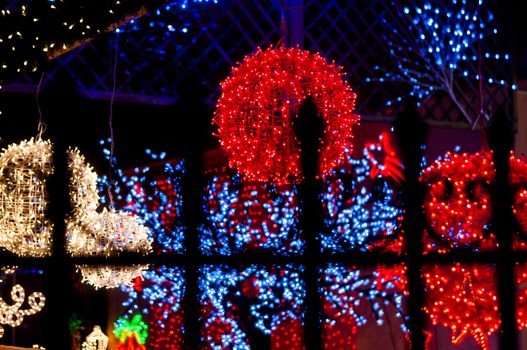 red light ball behind iron railings, many lights