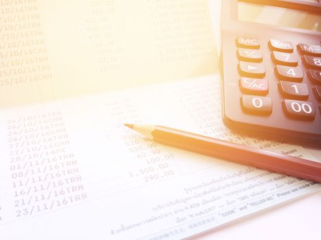 Business, finance, savings or loan background concept ; Pen, calculator and savings account passbook on white background