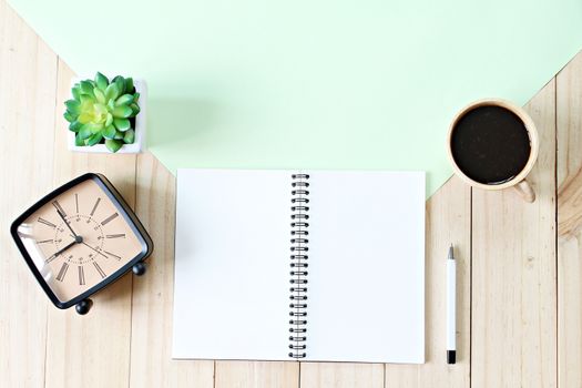 Still life, business, office supplies or education concept : Top view or flat lay of open notebook paper with blank pages, accessories and coffee cup on wooden background, ready for adding or mock up