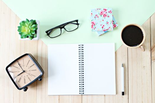 Still life, business, office supplies or education concept : Top view or flat lay of open notebook paper with blank pages, accessories and coffee cup on wooden background, ready for adding or mock up