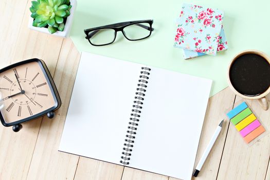 Still life, business, planning or education concept : Office desk table with open notebook paper, accessories and coffee cup, Top view or flat lay with copy space ready for adding or mock up