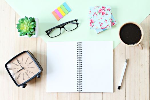 Still life, business, office supplies or education concept : Top view or flat lay of open notebook paper with blank pages, accessories and coffee cup on wooden background, ready for adding or mock up