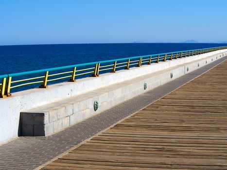 Beautiful beach seaside promenade with metal railings summer vacation attraction Spain