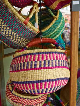 Colorful woven handmade classical traditional African Caribbean baskets for sale in a market