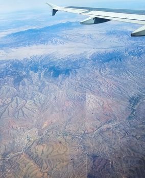 The vertical line in the middle section of the image is the border between the State of Arizona, USA, on the left side of the image, and the State of Sonora, Mexico, on the right side of the image.