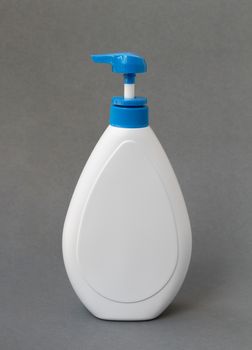 White lotion bottle on dark background, beauty skin care concept
