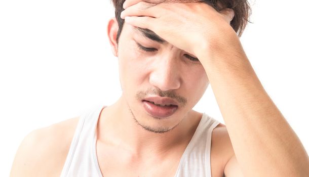 Young man suffering form headache with white background
