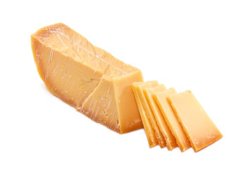 Piece and several slices of the Dutch hard cheese Beemster closeup on a white background
