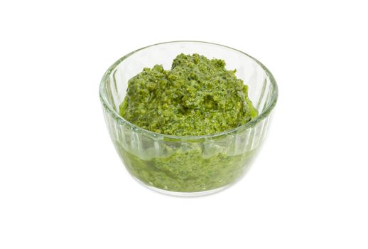 Sauce basil pesto in the small glass bowl on a white background

