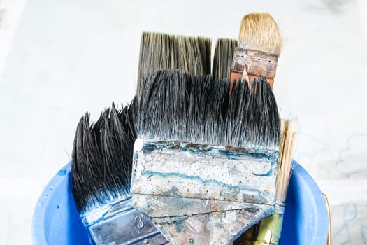 Close up of old paint brushes, grunge and rusty texture background