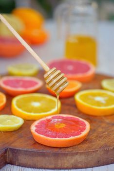 Slices of grapefruit, clementine, orange and honey