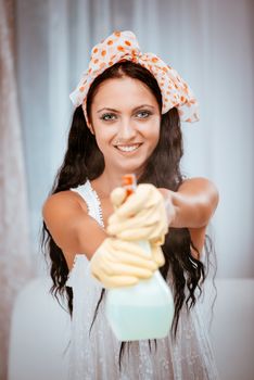 Young beautiful woman cleaning window. Selective focus.