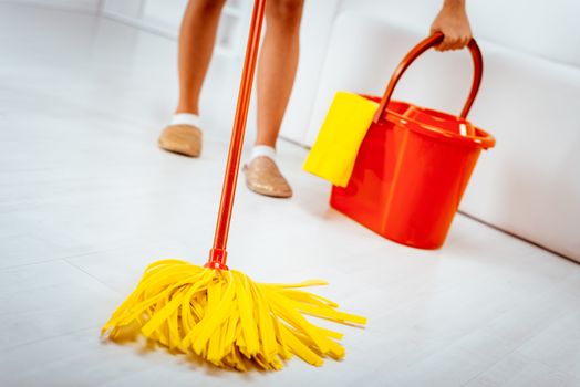 Close-up of a female maid scrubbing floor.