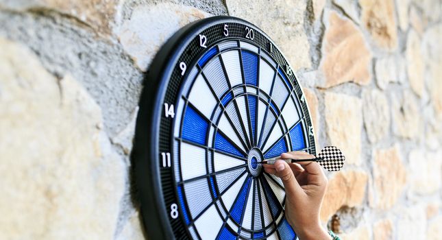 Bullseye on a wall with some darts