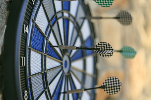 Bullseye on a wall with some darts