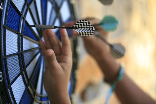 Bullseye on a wall with some darts