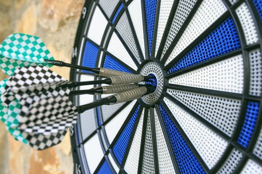 Bullseye on a wall with some darts