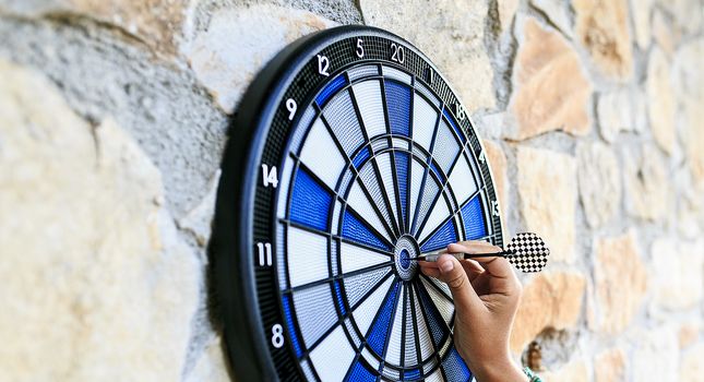 Bullseye on a wall with some darts