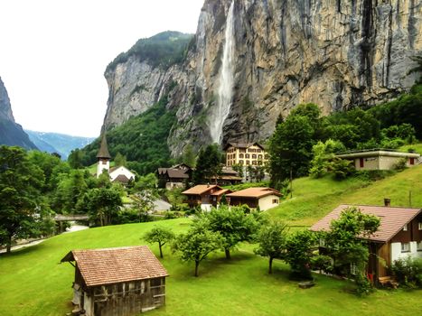 Beautiful Staubbachfall waterfall flowing down the picturesque Lauterbrunnen valley and village in Bern canton, Switzerland, Europe