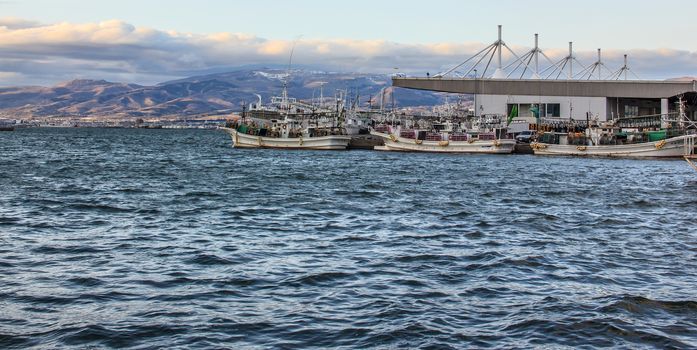 Ships standby at the harbour on windy day in Hakodate Bay, Hakodate, Hokkaido, Japan.