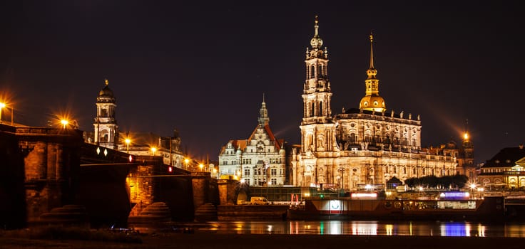 Night summer beautiful panoramic view of Cathedral of the Holy Trinity or Hofkirche, Bruehl's Terrace or the Balcony of Europe on Elbe river, Dresden, Saxony, Germany, Europe.