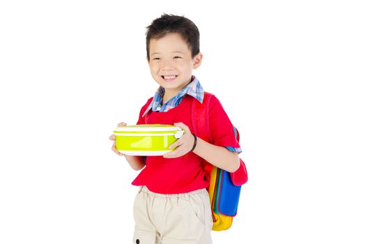 Asian primary school boy holding lunch box. Healthy eating concept for schoolchild.