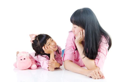 Asian mother and daughter smiling and looking at each other.