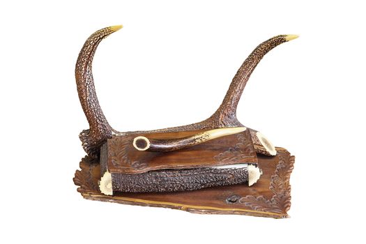 ancient piece of furniture with hunting motifs, isolation of handmade drawer over white background; it is made from wood and red deer pieces of antlers ( Cervus elaphus )