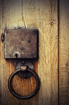 detail of old oak wood gate with rusty metallic hasp