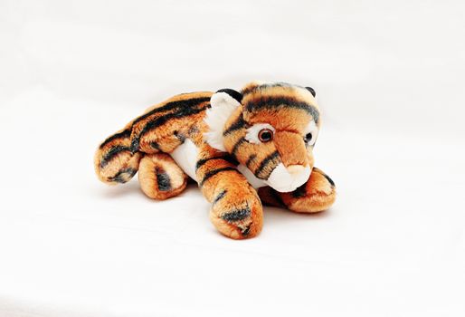 Soft children's toy striped tiger isolated white background.