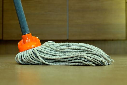 closeup of cleaning the ceramic floor with a mop