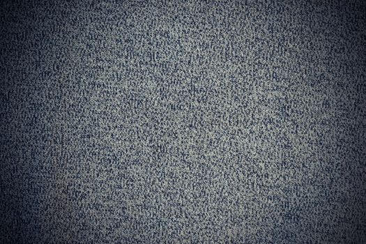 texture of gray crocheted sweater material with vignette